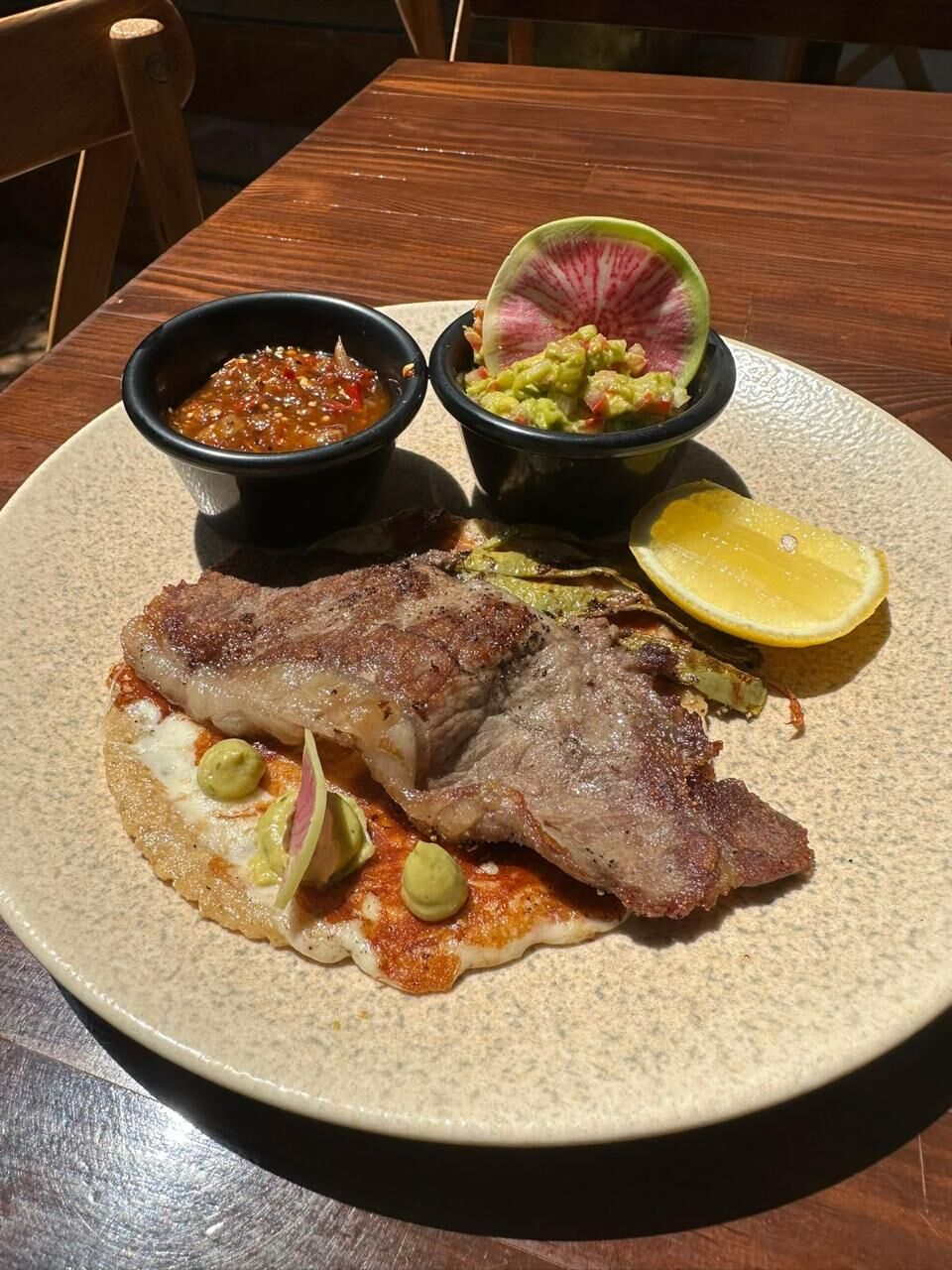 Special rib eye taco with a crispy cheese crust, guacamole and grilled cactus, with salsa and guacamole on the side
